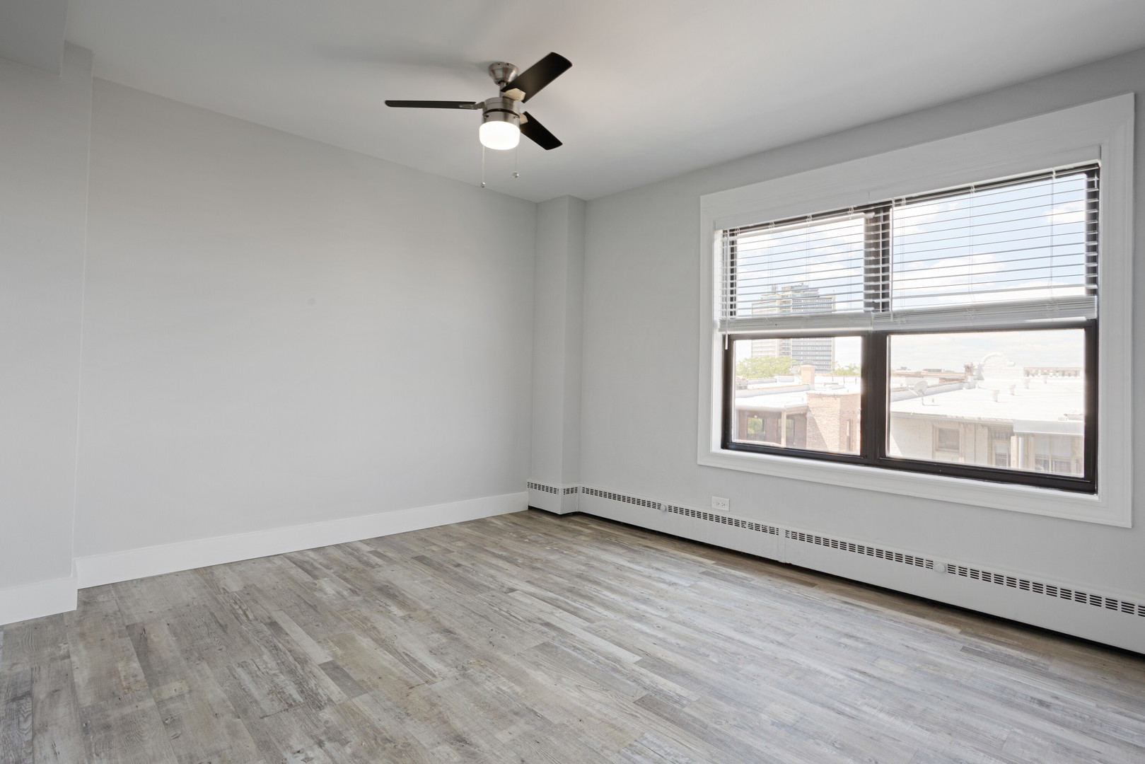 5858 North Sheridan Road, Unit 508 Chicago, IL 60660 - Photo 9 of 17 an empty room with wooden floor and windows