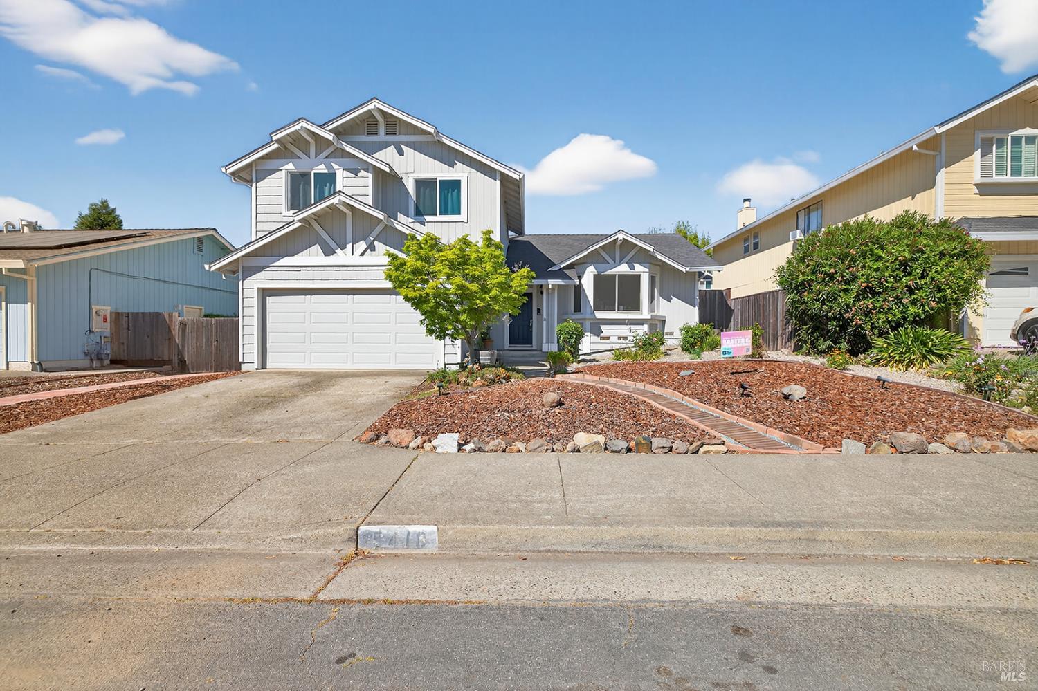 a front view of a house with a yard and a garage