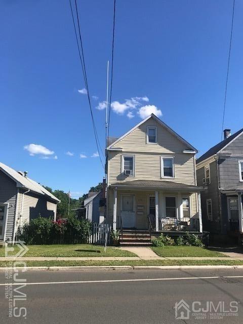 578 Bound Brook Road Middlesex, NJ 08846 - Photo 1 of 7 a view of a big house with a yard and table and chairs under an umbrella