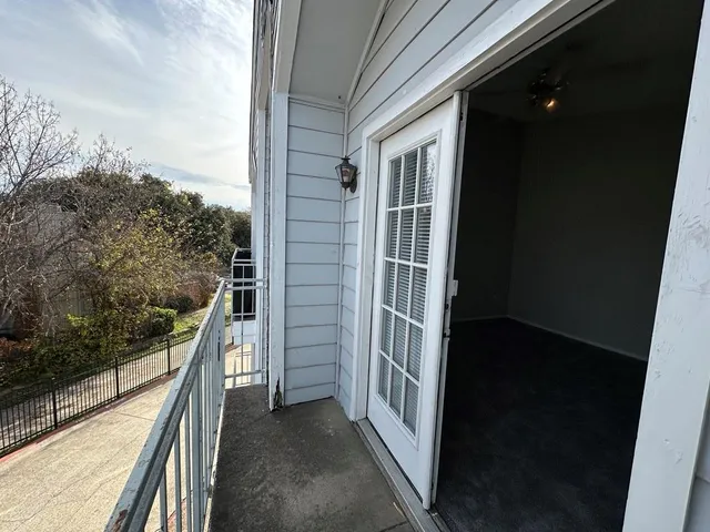 a view of a balcony with a trees