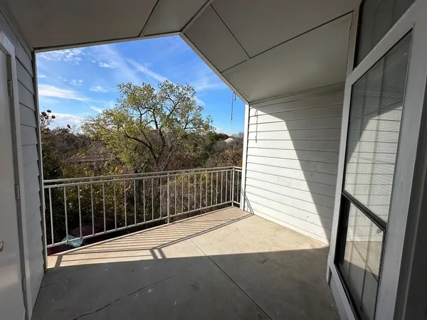 a view of balcony and yard