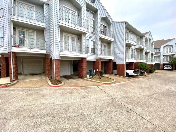 a view of a building with cars parked
