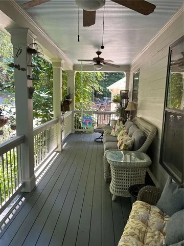 a living room with furniture floor to ceiling window and wooden floor