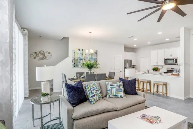a view of a dining room with furniture and chandelier