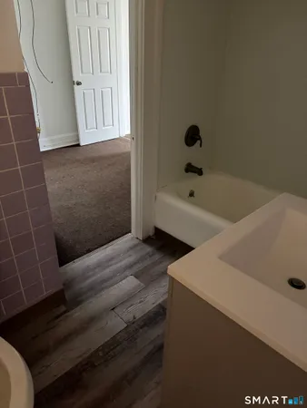 a bathroom with a bathtub and shower