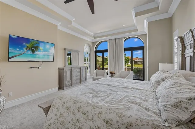 a spacious bedroom with a bed and a large window