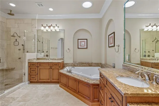 a spacious bathroom with a granite countertop tub sink and mirror