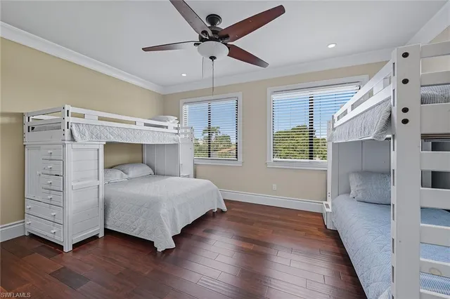 a bedroom with a bed and a ceiling fan