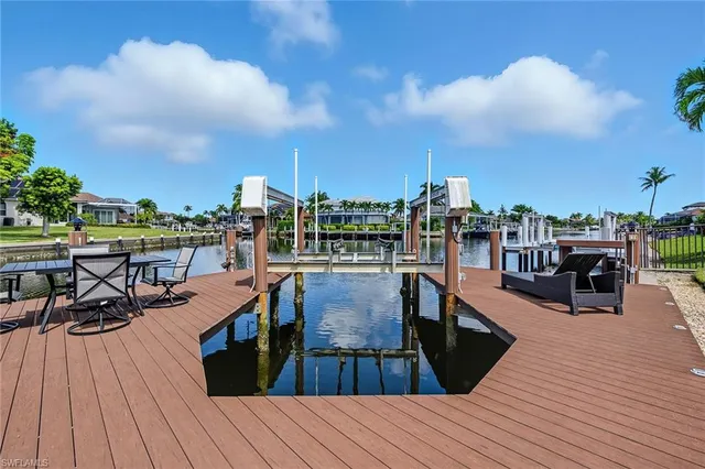 a view of a balcony with wooden floor and outdoor seating