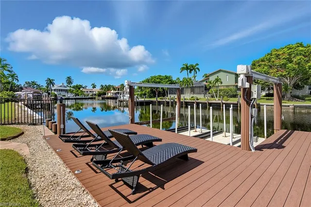 an aerial view of a house with swimming pool patio and outdoor seating