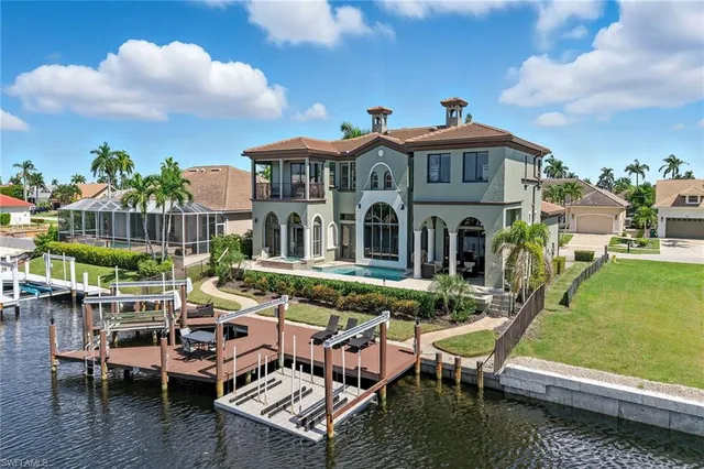 an aerial view of a house with swimming pool and outdoor space