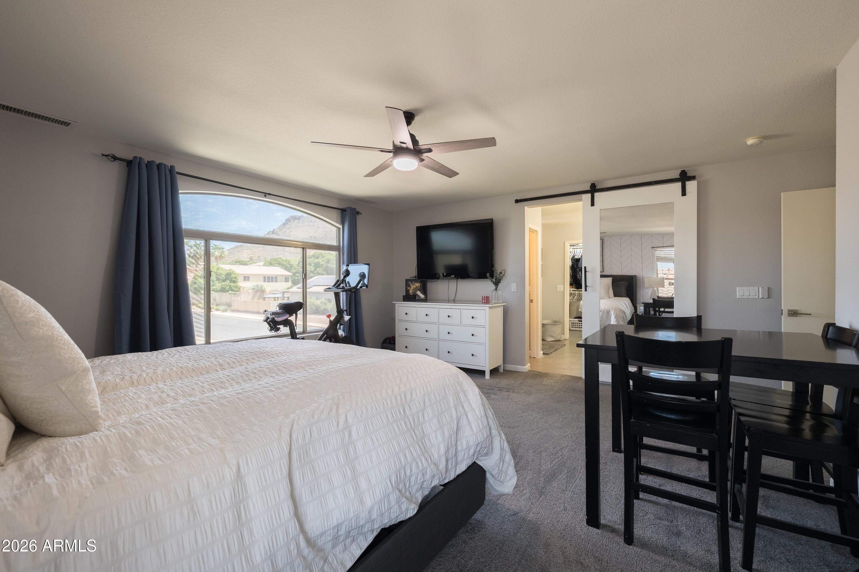 6407 West Saddlehorn Road Phoenix, AZ 85083 - Photo 37 of 41 a spacious bedroom with a large bed and a chandelier