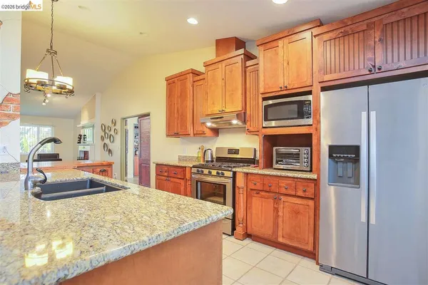 a kitchen with stainless steel appliances a stove top oven and cabinets
