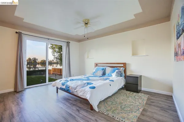 a bedroom with a bed and a large window