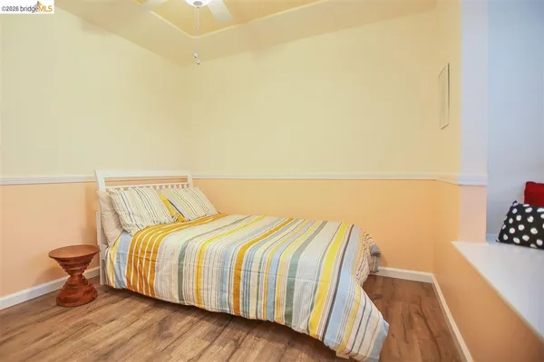 a bedroom with a bed and a wall painting