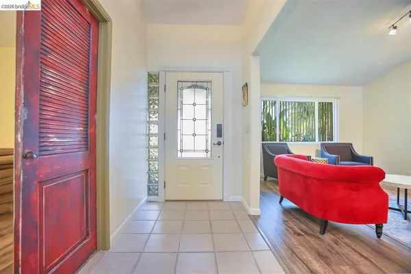 a living room with furniture and a floor to ceiling window