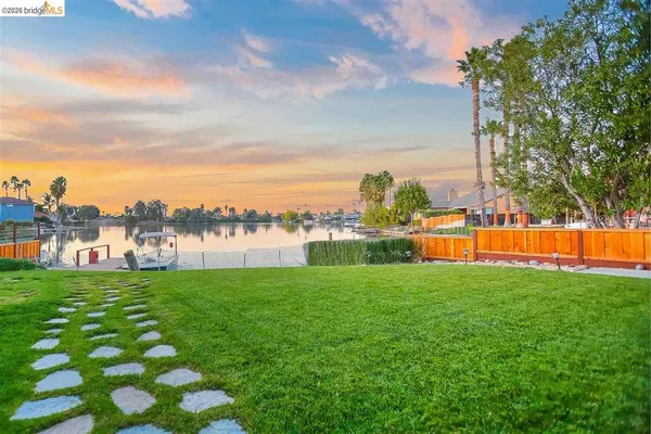 a roof deck with table and chairs a barbeque with potted plants