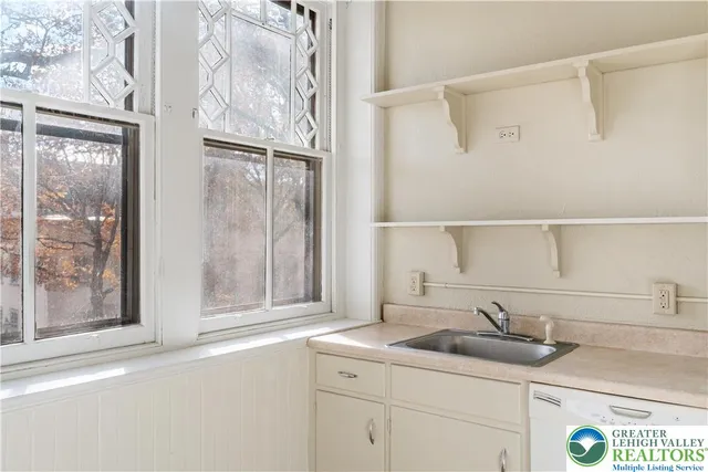 a hallway with a painting on the wall and a window