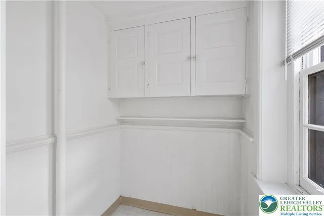 a view of living room with a large window and mirror