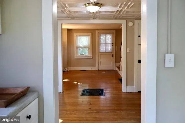 a view of a hallway with a dining room