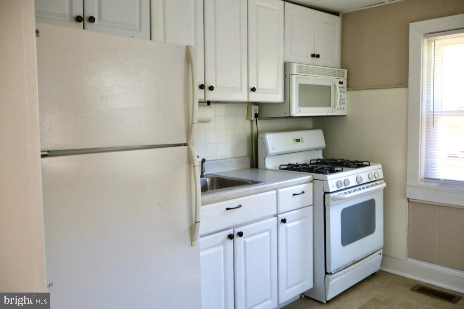 37 Moran Avenue Princeton, NJ 08542 - Photo 7 of 15 a kitchen with white cabinets and white appliances