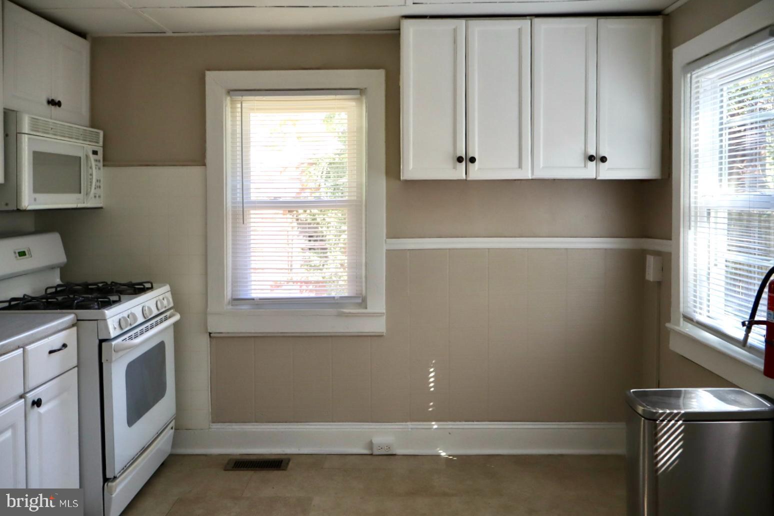 37 Moran Avenue Princeton, NJ 08542 - Photo 8 of 15 a kitchen with white cabinets and a stove