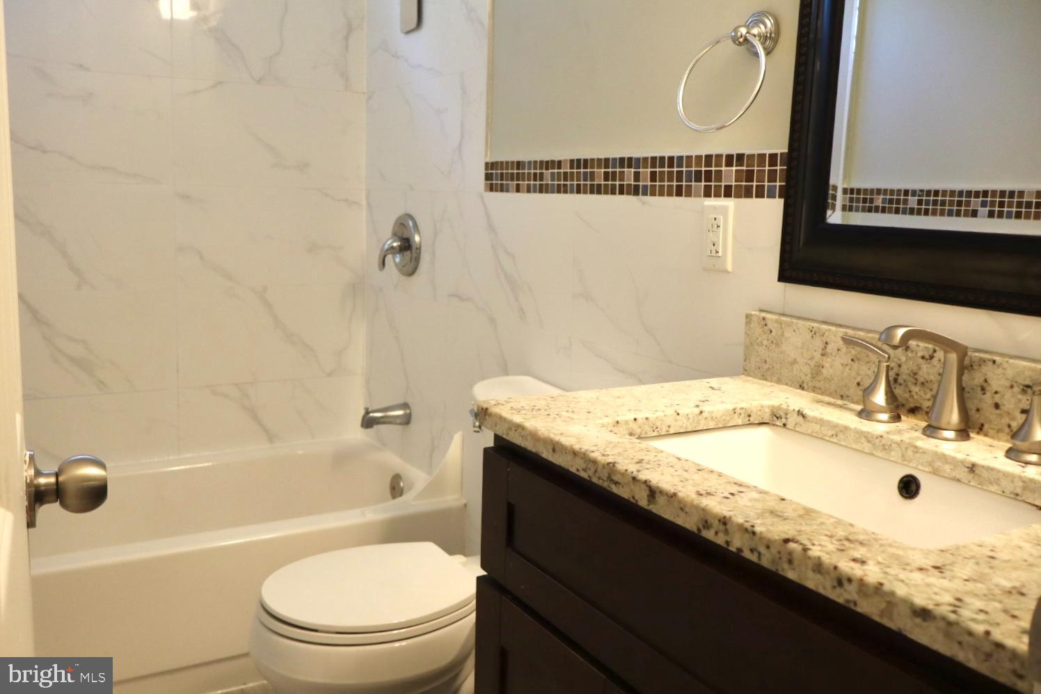 37 Moran Avenue Princeton, NJ 08542 - Photo 10 of 15 a bathroom with a granite countertop sink a toilet and bathtub
