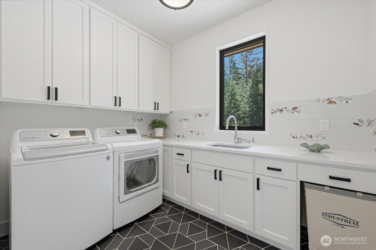 7416 Lake Alice Road Southeast Fall City, WA 98024 - Photo 13 of 40 a utility room with cabinets washer and dryer