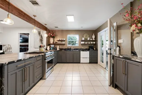 a large kitchen with stainless steel appliances lots of counter space sink and cabinets