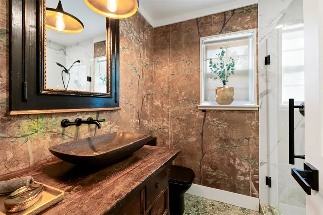 a bathroom with a sink a mirror and a shower