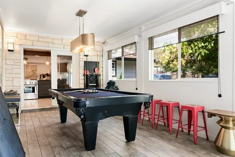a living room with dining table and a wooden floor