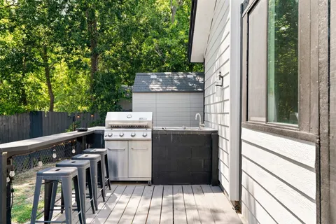 a view of a patio with table and chairs and a stove