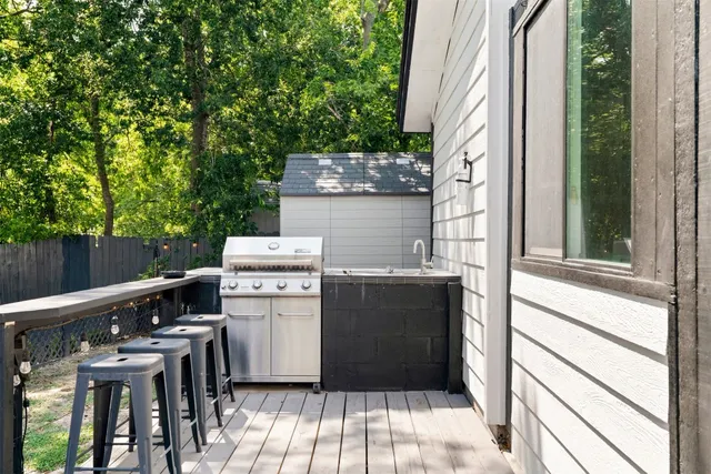 a view of a patio with table and chairs and a stove
