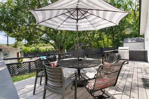 a patio with a patio table and chairs