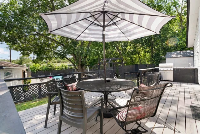 a patio with a patio table and chairs