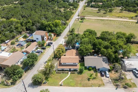 an aerial view of a house with a garden and swimming pool