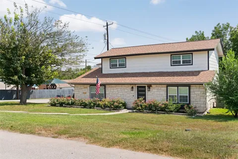 a front view of house with yard and green space