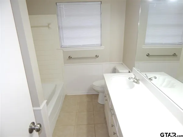 a bathroom with a sink a toilet and a bathtub