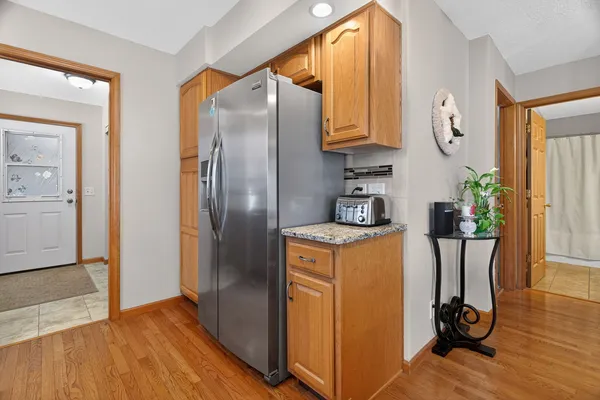 a dining room with furniture a chandelier and wooden floor