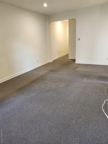 a view of kitchen with refrigerator and window
