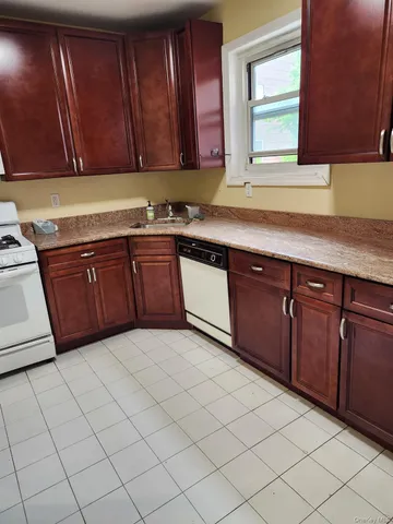 a kitchen with a cabinets and white appliances