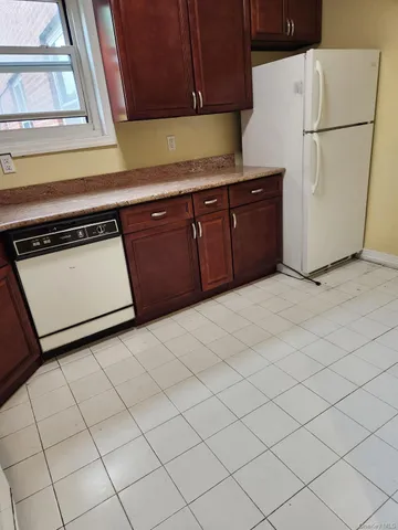 a view of a hallway with a livingroom and a chair