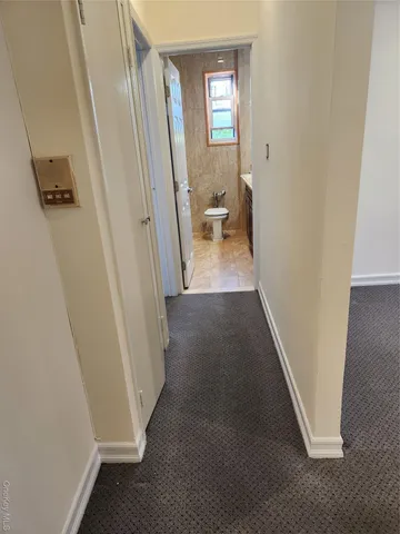 a bathroom with a granite countertop sink a toilet and a mirror