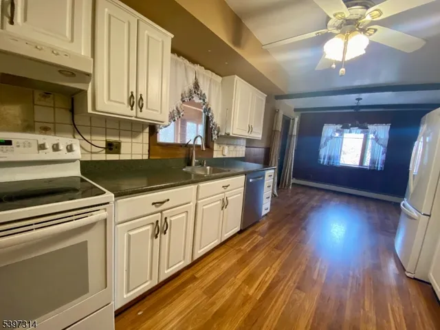 a view of a kitchen with wooden floor
