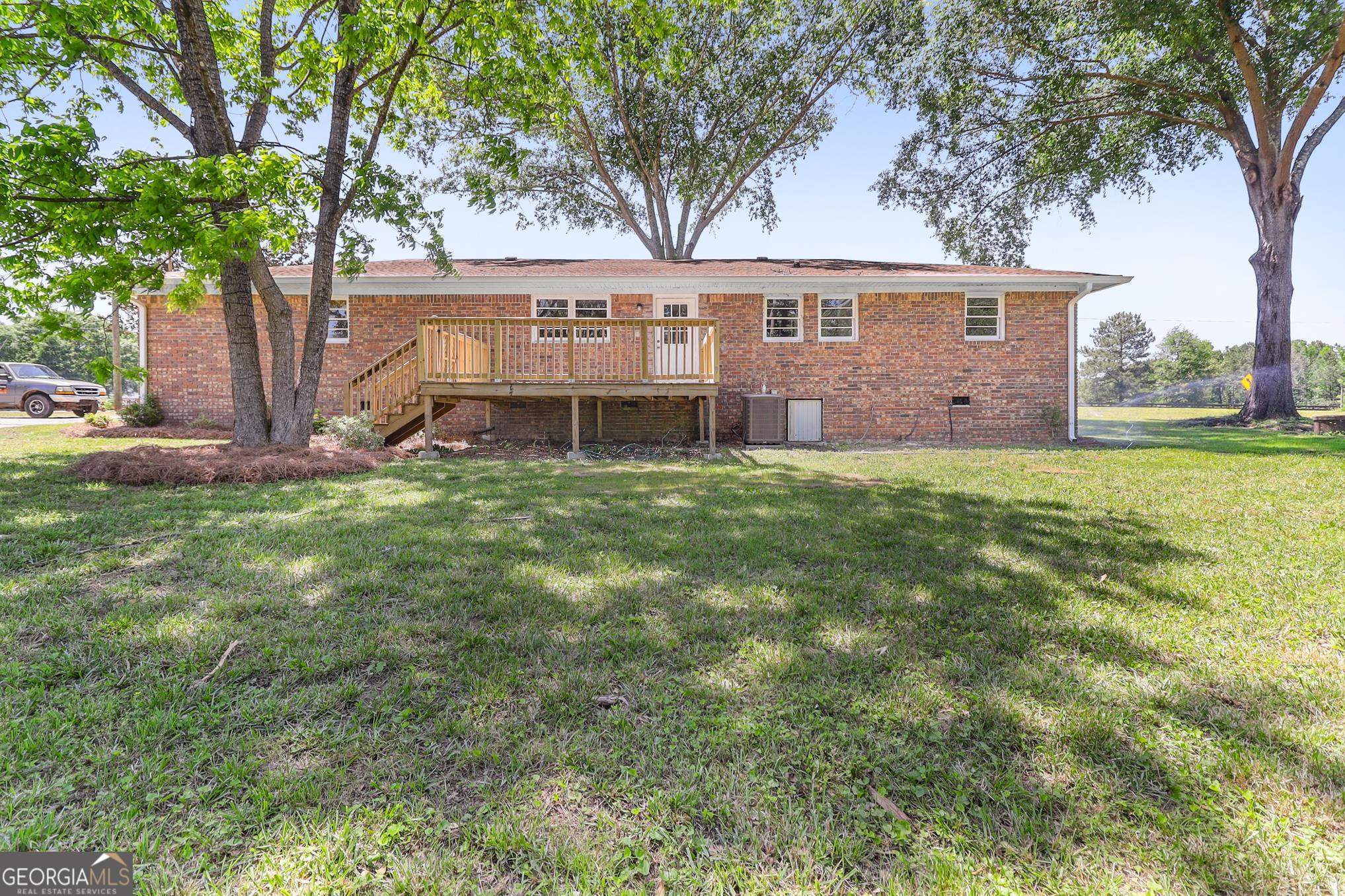 55 Welcome Sargent Road Newnan, GA 30263 - Photo 18 of 20 a view of a yard in front of a house with large tree