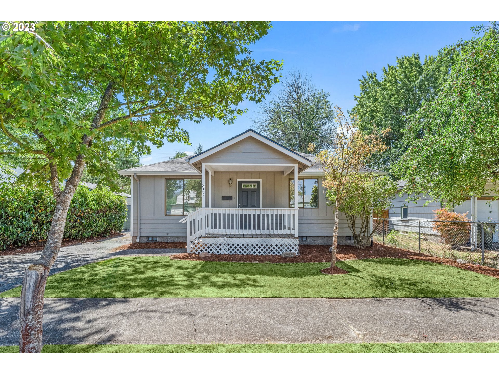 835 L Street Springfield, OR 97477 - Photo 1 of 40 a front view of a house with a garden