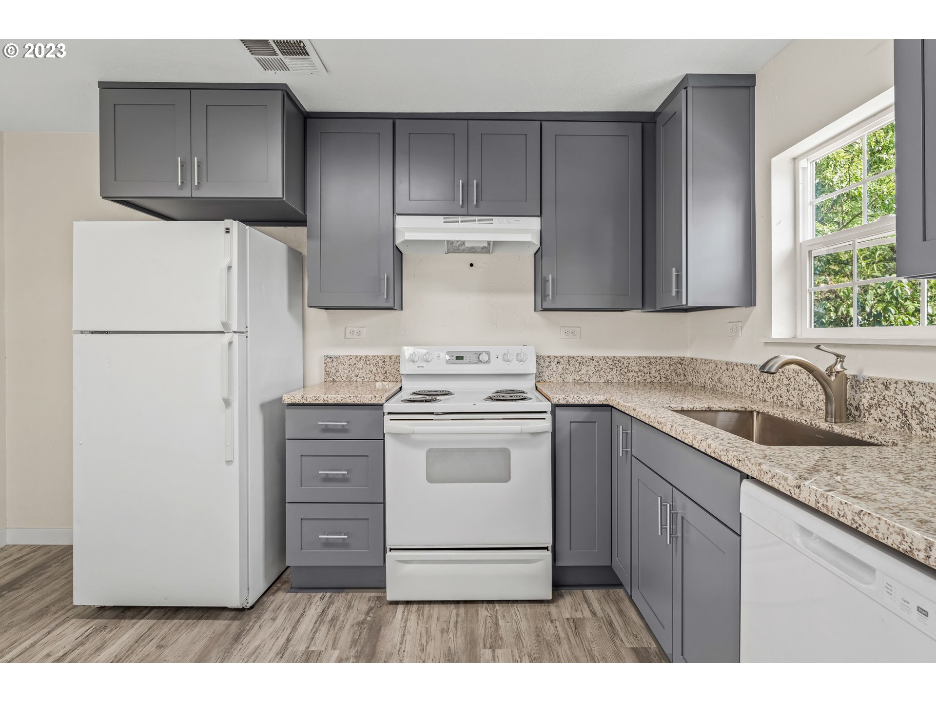 835 L Street Springfield, OR 97477 - Photo 12 of 40 a kitchen with a stove a sink and a refrigerator
