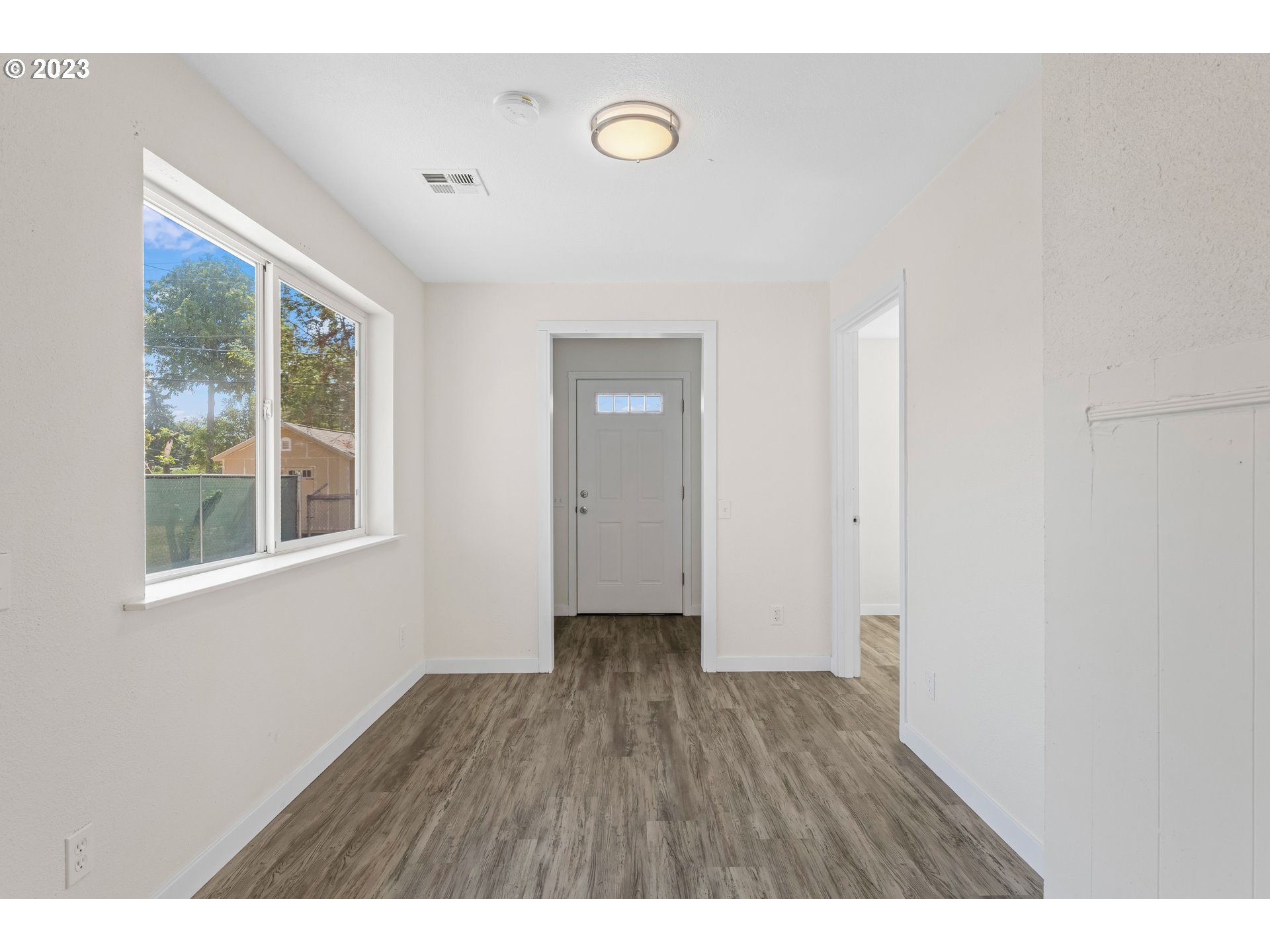 835 L Street Springfield, OR 97477 - Photo 13 of 40 a view of an empty room with wooden floor and windows