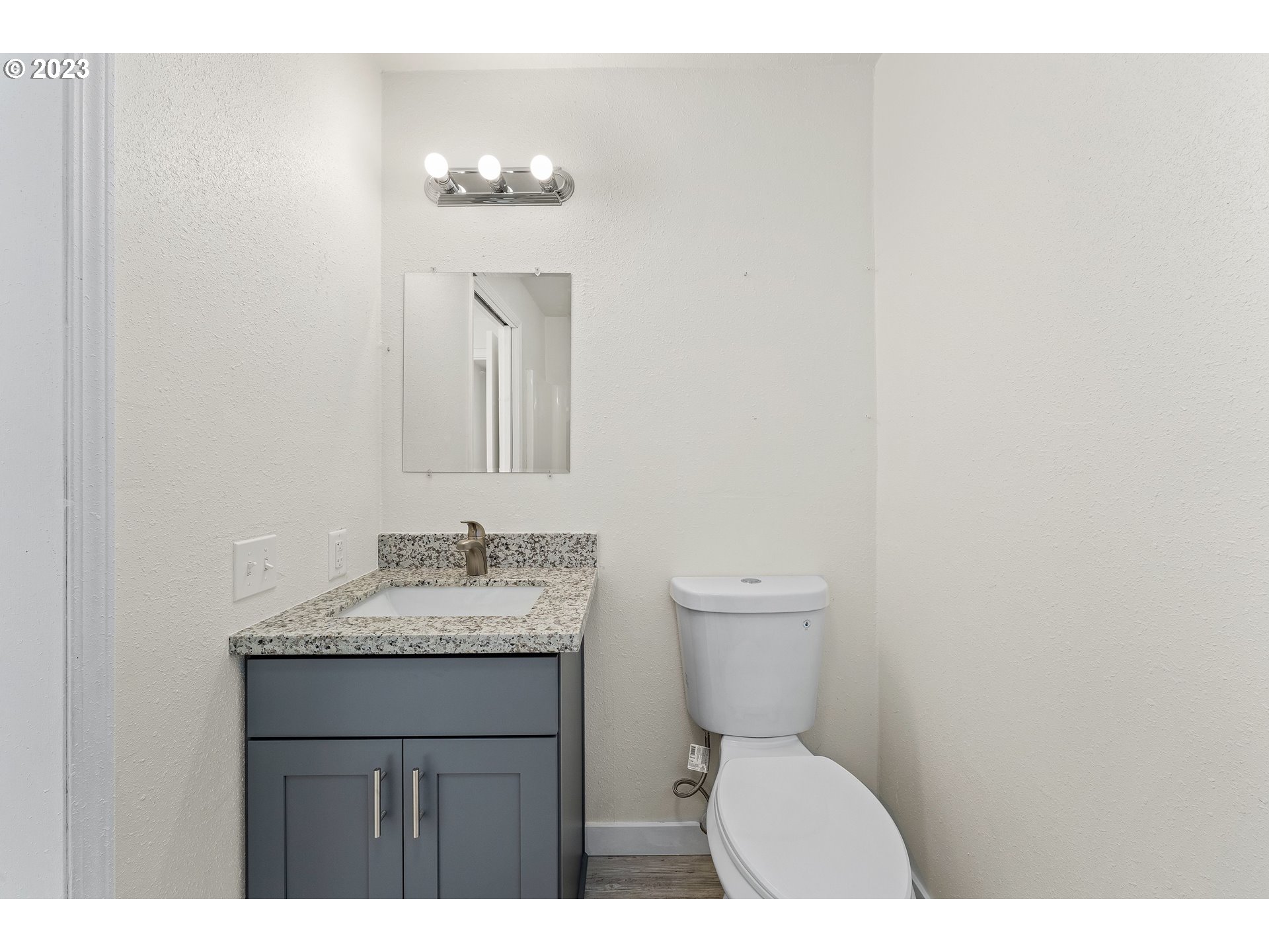 835 L Street Springfield, OR 97477 - Photo 22 of 40 a bathroom with a toilet sink and mirror