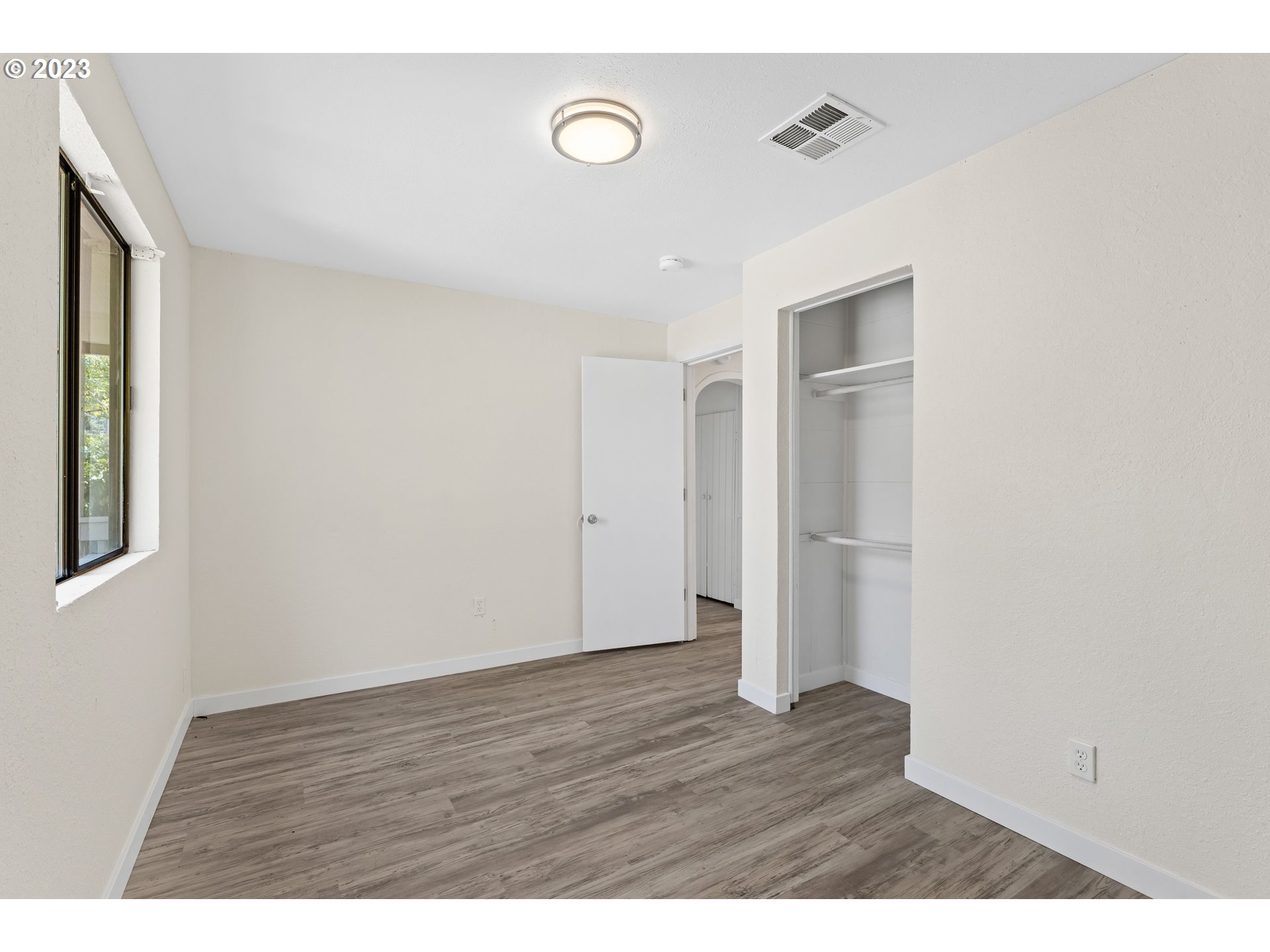 835 L Street Springfield, OR 97477 - Photo 26 of 40 a view of an empty room with wooden floor